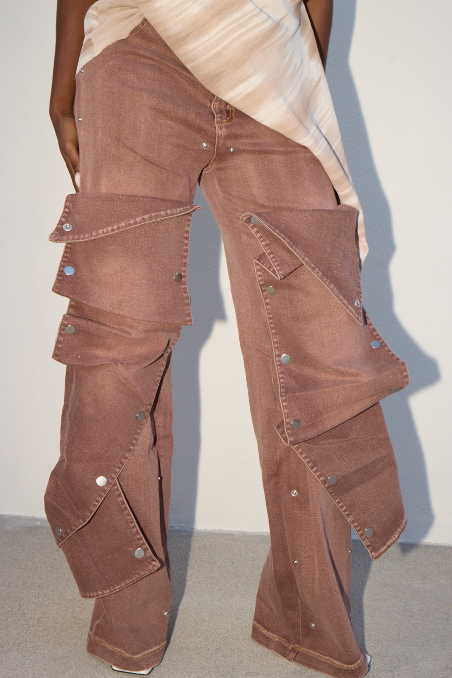 Brown cargo pants worn by a person against a plain background